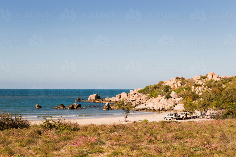 Beach with grass and rocks in the afternoon - Australian Stock Image