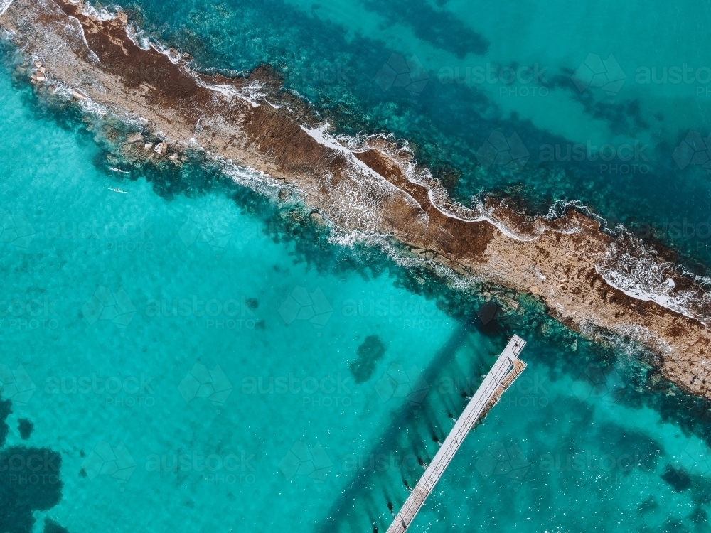 Beach with reef and jetty from above - Australian Stock Image