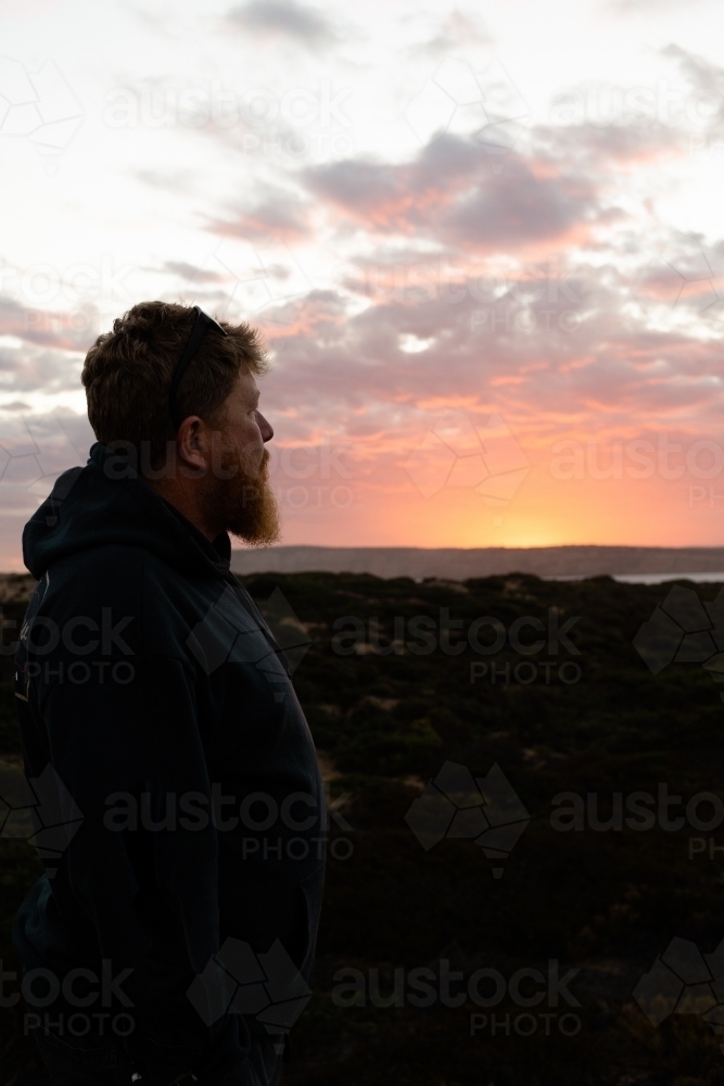 Bearded man gazing into the sunset - Australian Stock Image