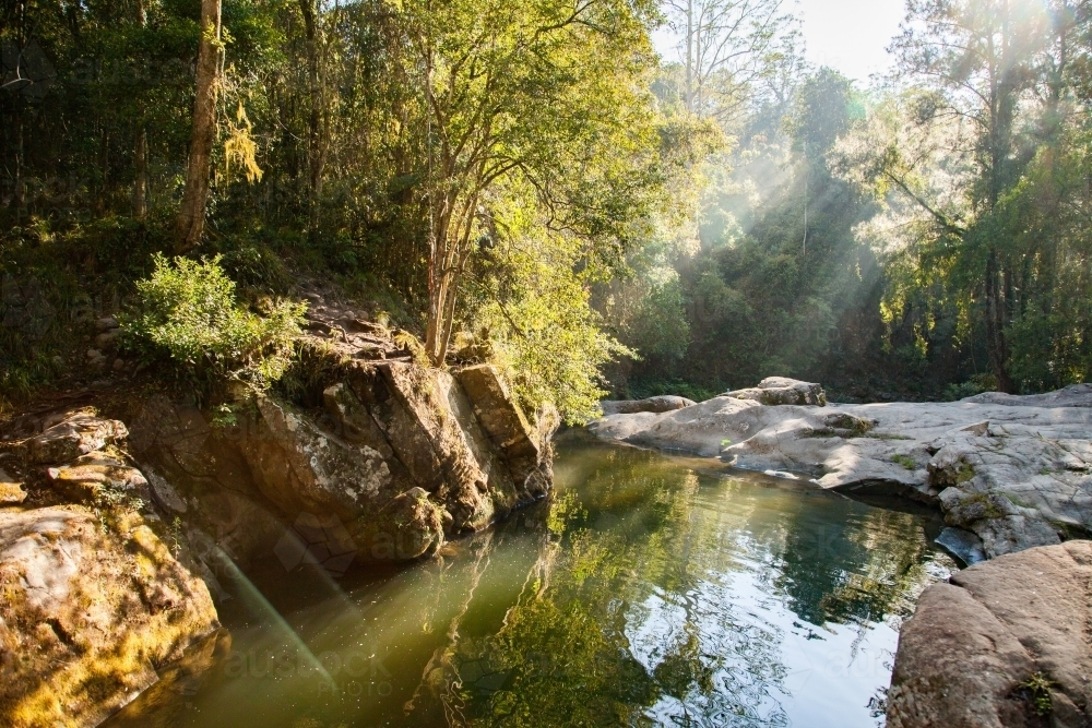 Beautiful quiet scenery with sun flare over Ladies Well, Allyn River - Australian Stock Image