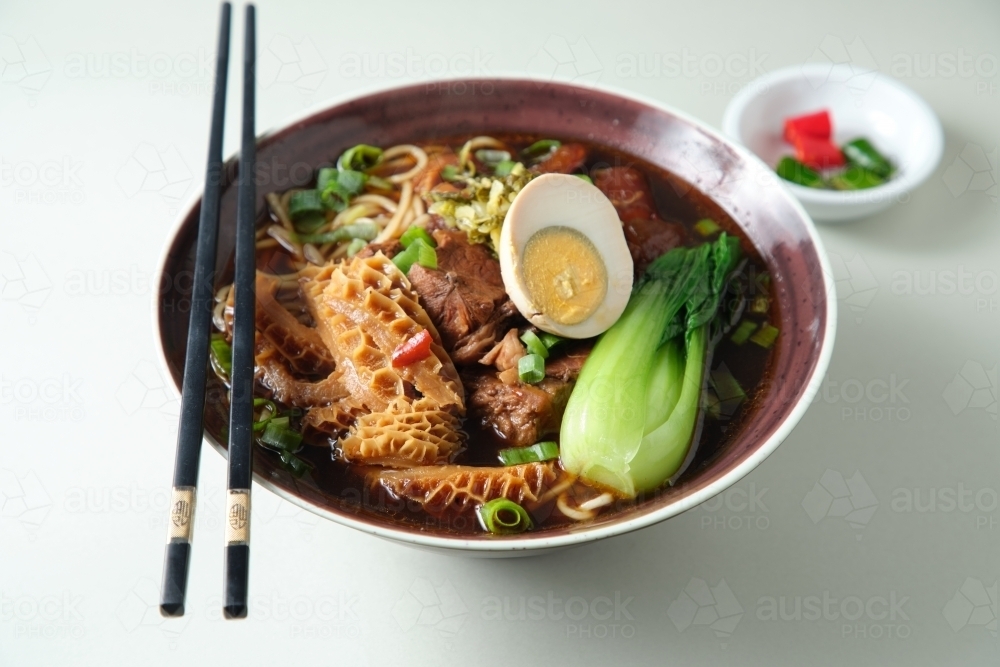 Beef gravy and tripe and tendon noodle soup - Australian Stock Image