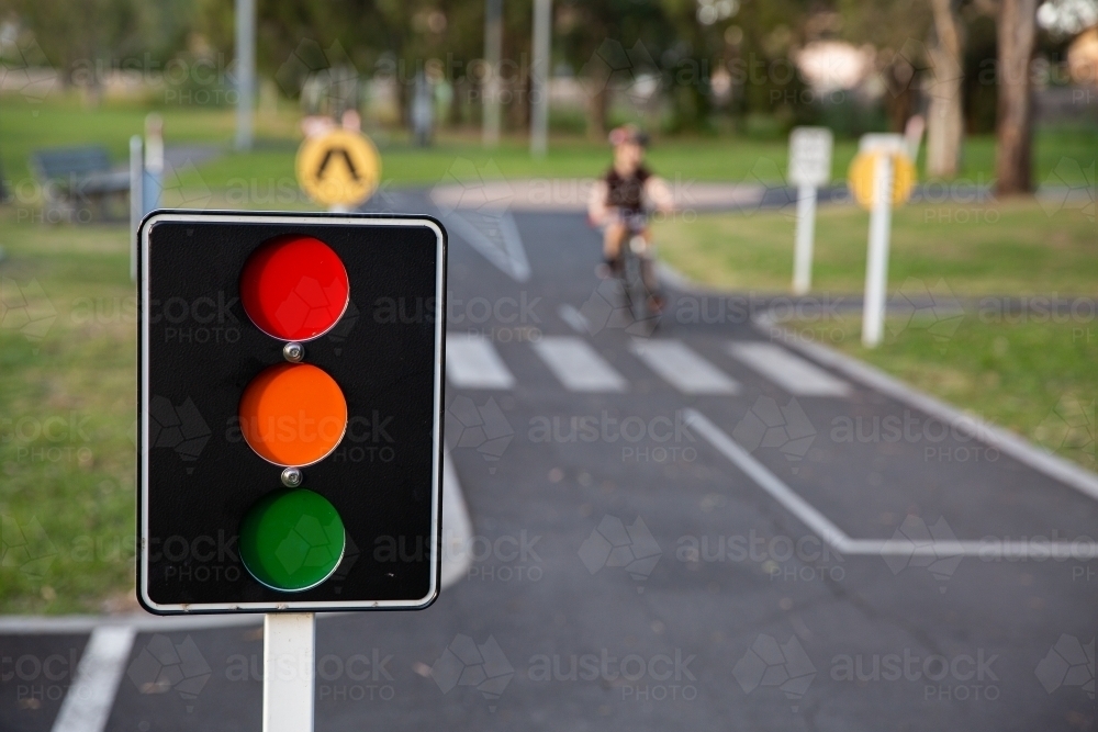 bike path with road markings and traffic lights in a public park - Australian Stock Image