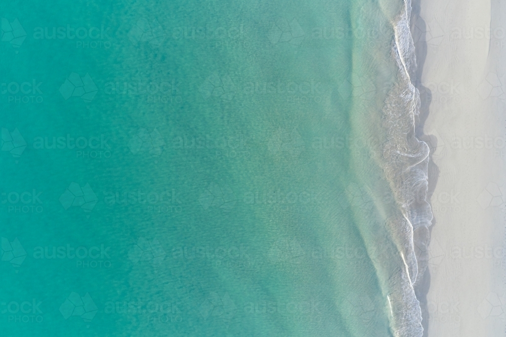 Bird's eye view of crystal clear turquoise water at a sandy beach in Perth, Western Australia - Australian Stock Image