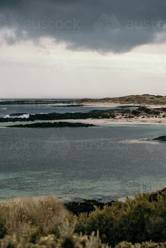 Black storm cloud over the beach. - Australian Stock Image