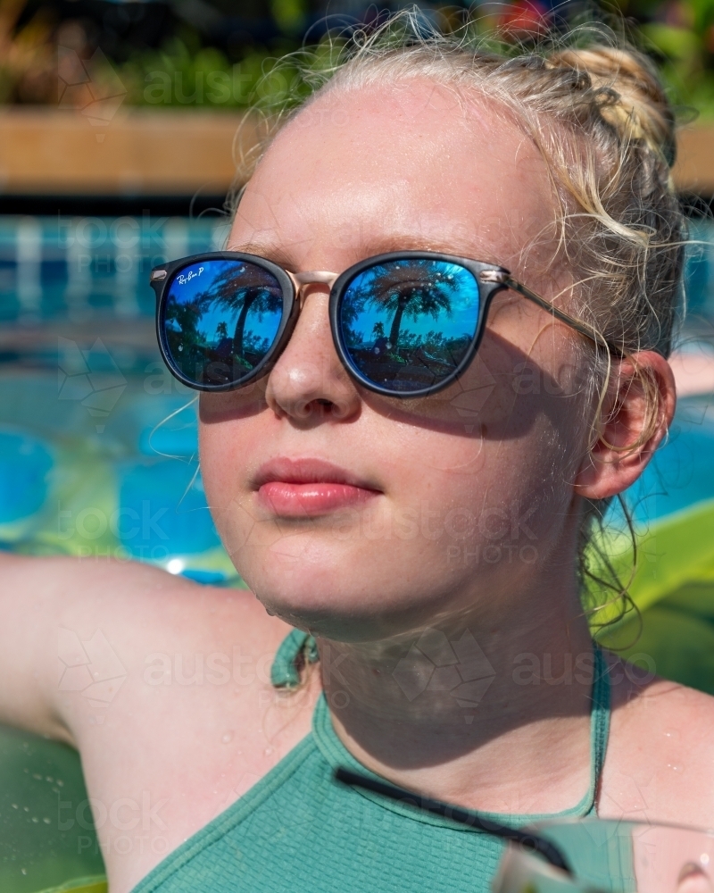 Blonde Girl Looking up At Palm Trees - Australian Stock Image