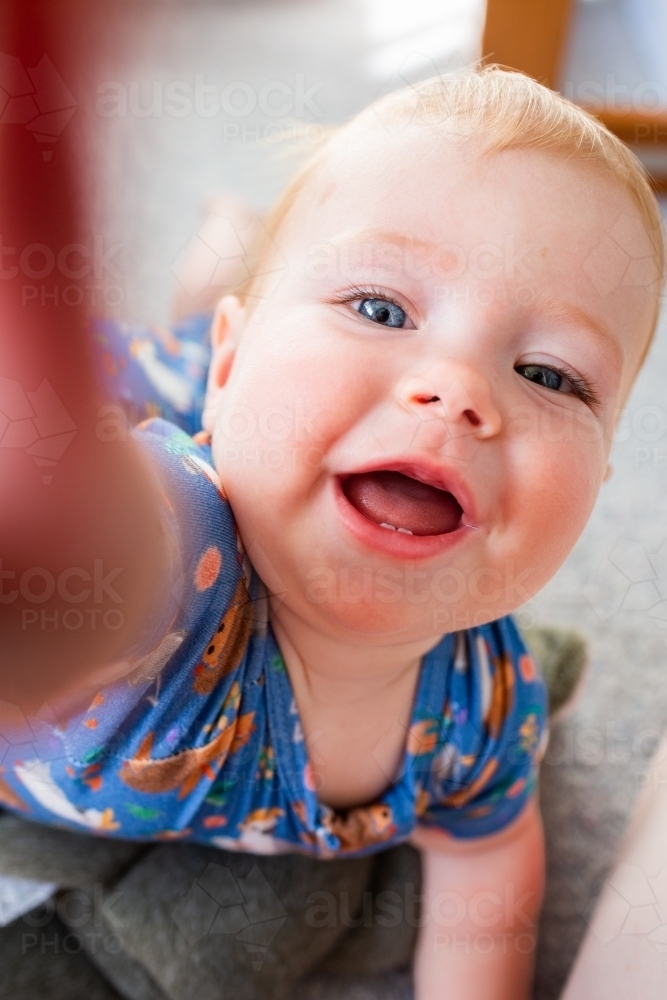 Image of Blue eyed baby selfie look photo with child poking camera lens ...