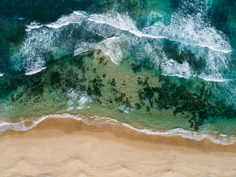 blue green ocean water with waves incoming to shore - aerial overhead view - Australian Stock Image