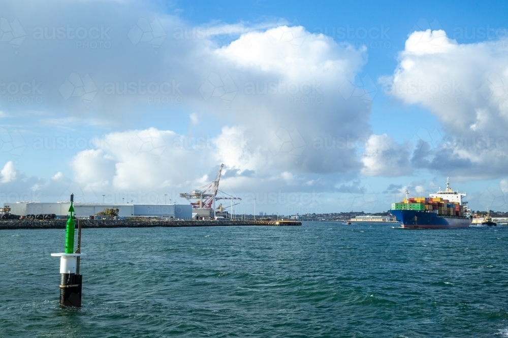 Blue hulled container ship departing port. - Australian Stock Image