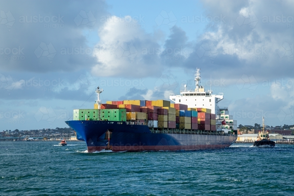 Blue hulled container ship departing port. - Australian Stock Image