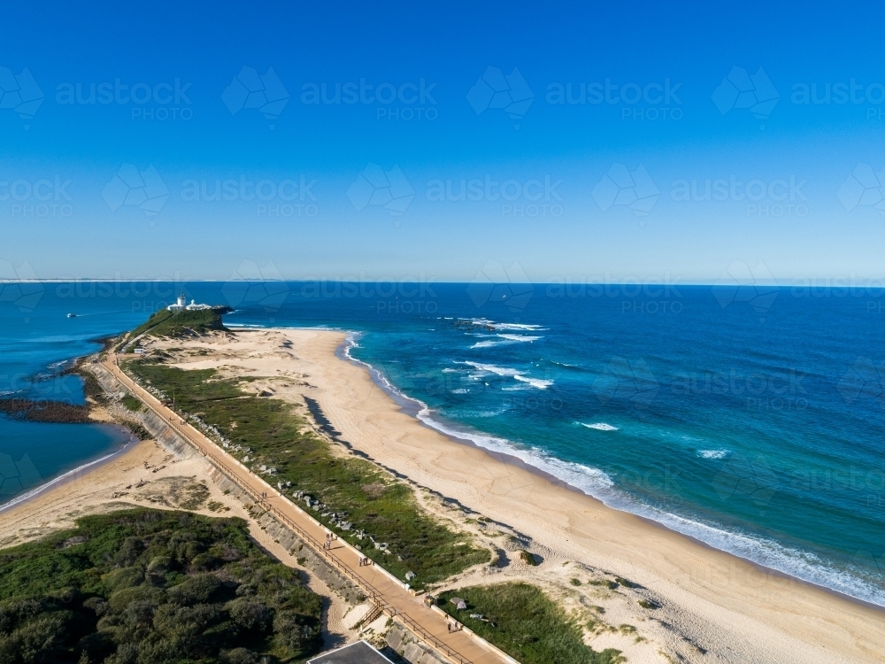 Blue ocean water and sunlit beach in Newcastle NSW seen from aerial view - Australian Stock Image