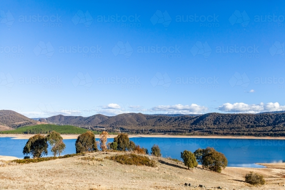 Blue sky and mountains with lake, Blowering Reservoir - Australian Stock Image