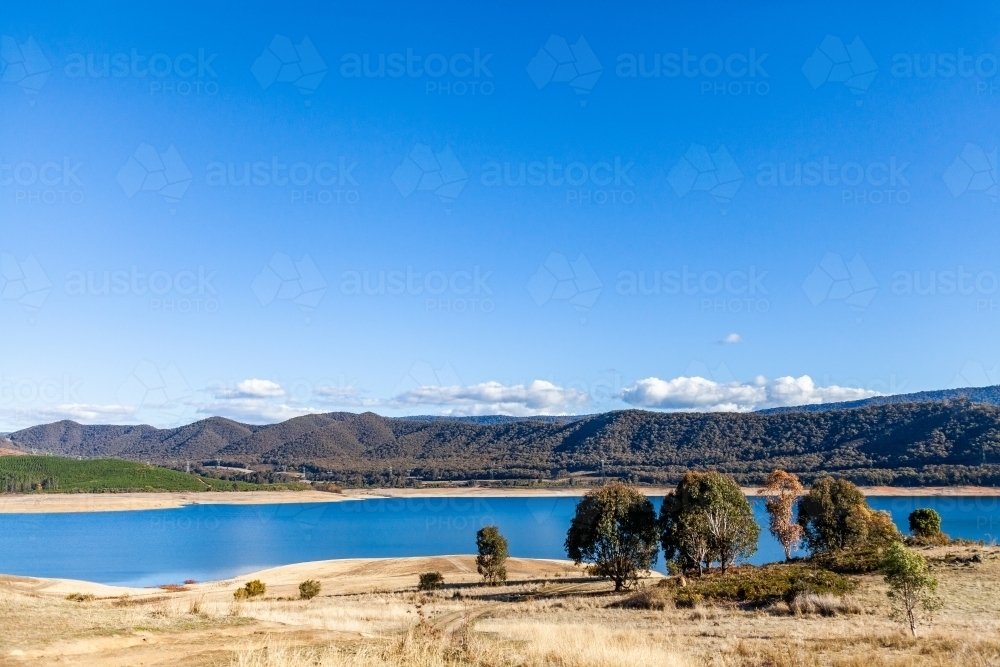 Blue sky and mountains with lake, Blowering Reservoir - Australian Stock Image