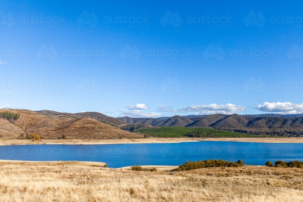 Blue sky and mountains with lake, Blowering Reservoir - Australian Stock Image