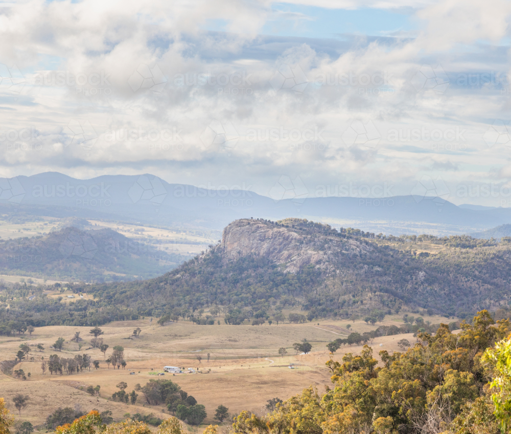 Bluff Rock, a granite outcrop overlooking brown country fields underneath a cloudy sky - Australian Stock Image