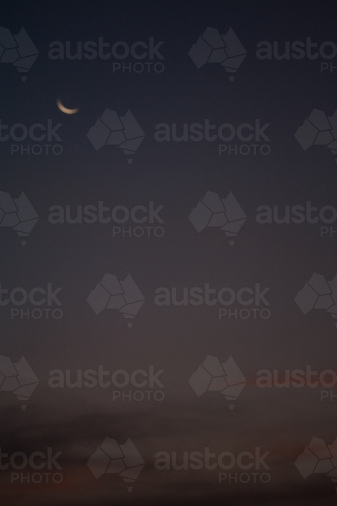 Blurred evening sky with crescent moon - Australian Stock Image