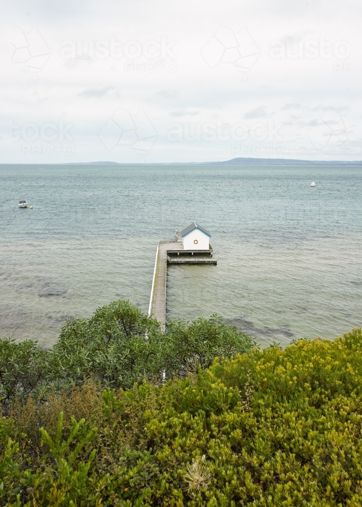 Boat shed at the end of a long jetty - Australian Stock Image