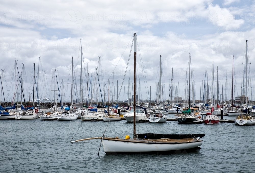 boats anchored in harbour with Melbourne skyline in background - Australian Stock Image