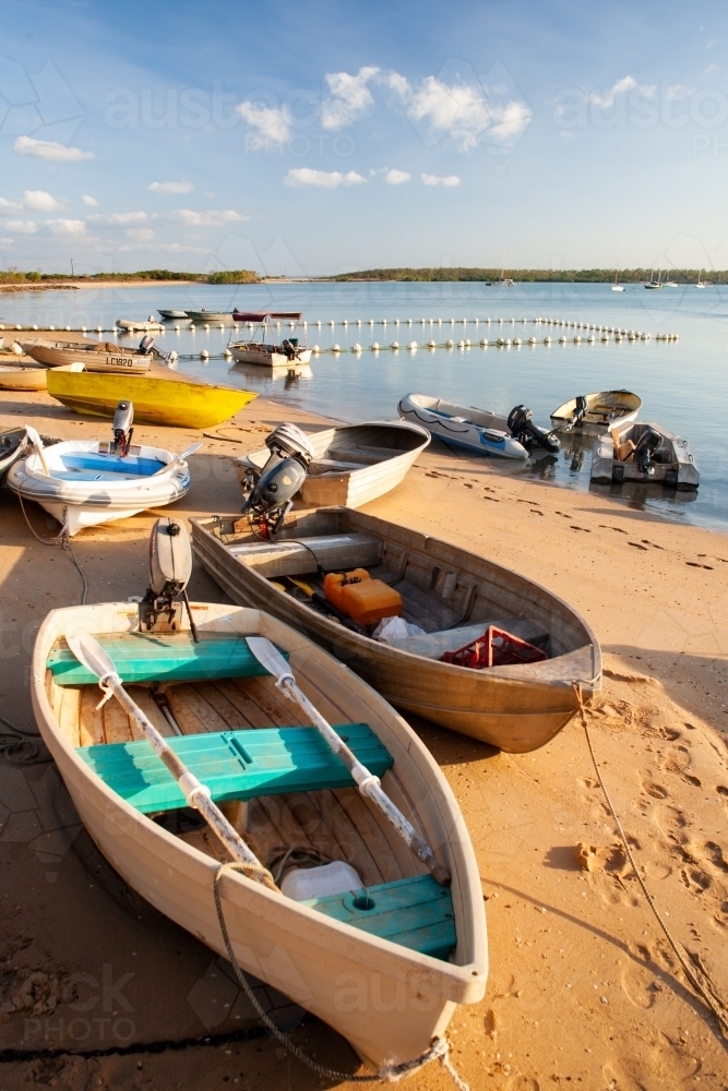 Boats sitting on the sand late in the afternoon at the Gove Yatch Club. - Australian Stock Image