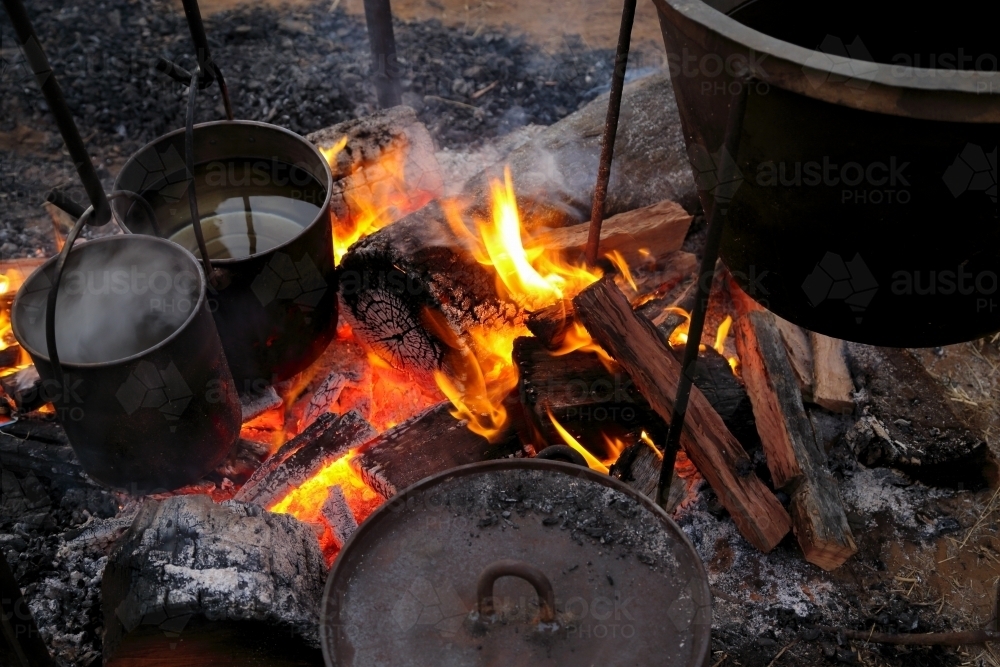 Boiling the billy over a camp fire. - Australian Stock Image