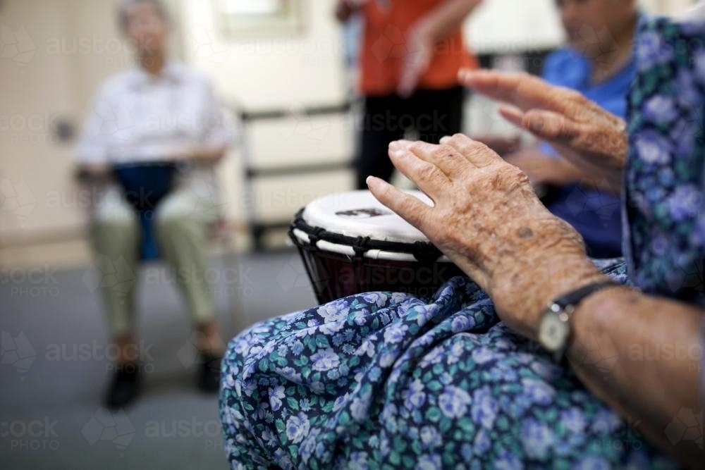 Bongo drumming activity session at retirement village - Australian Stock Image