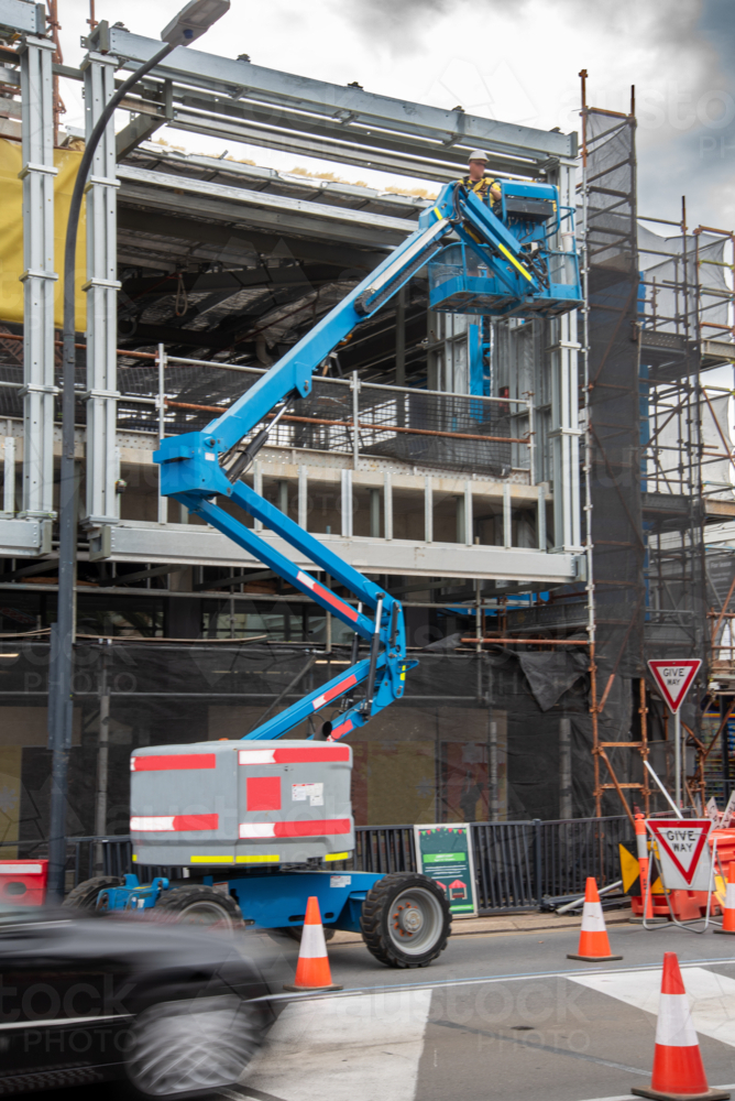 Boom lift in action on construction site - Australian Stock Image