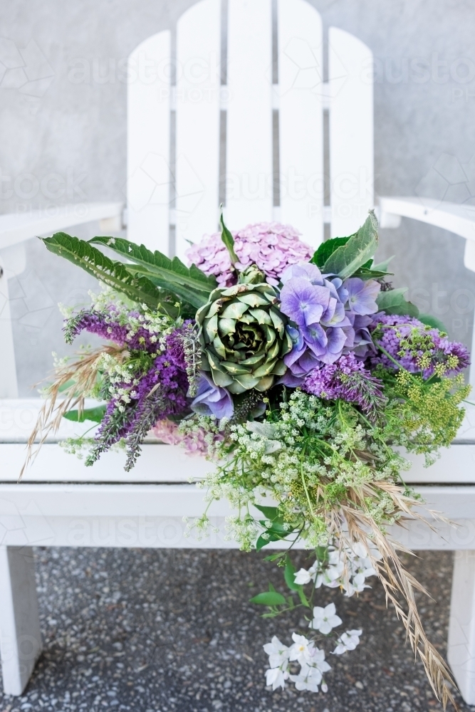 Bouquet of flowers on a garden seat - Australian Stock Image