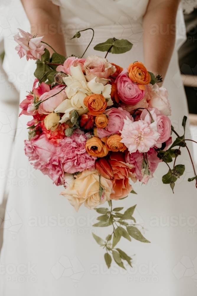 Bouquet of Orange and Pink Flowers Held by Bride - Australian Stock Image