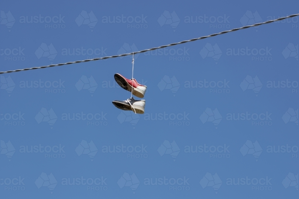 bowling shoes hanging on an electrical wire - Australian Stock Image