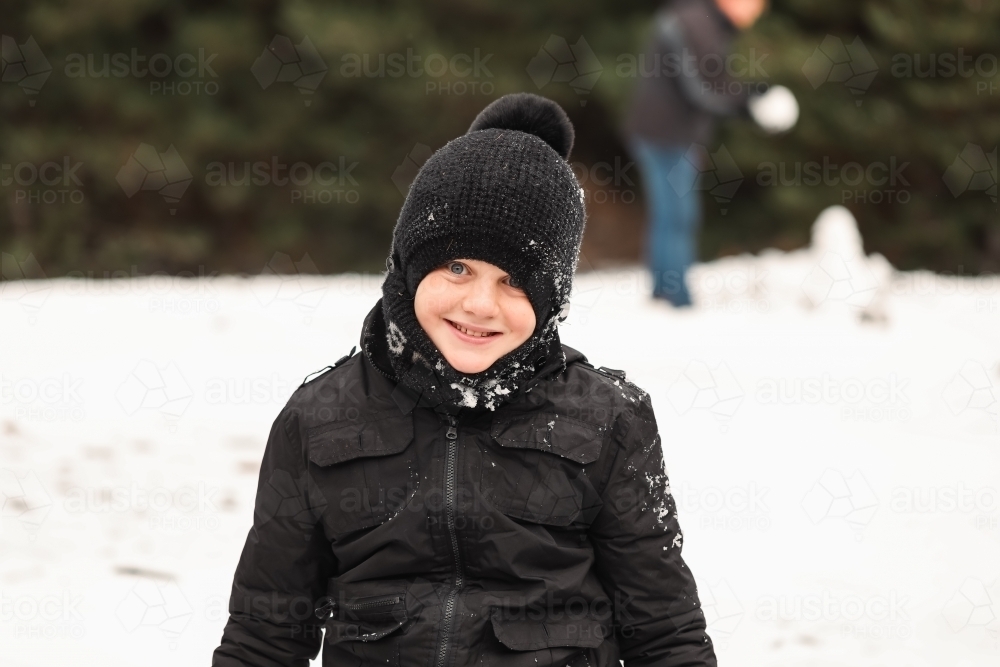 Boy playing in the snow at Shooter's Hill, NSW - Australian Stock Image