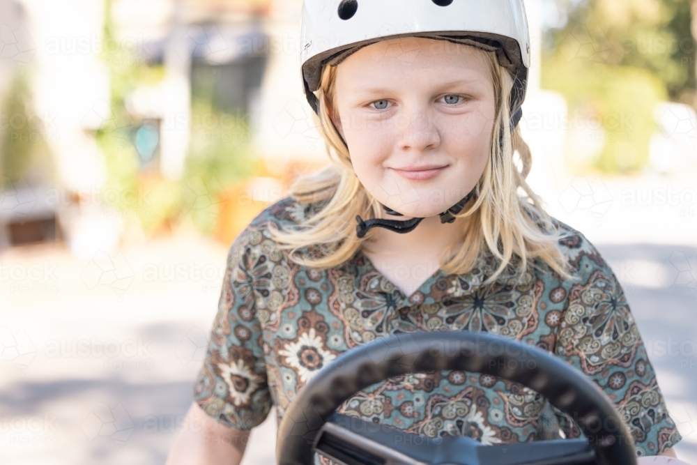 Boy riding pedal cart at caravan park - Australian Stock Image