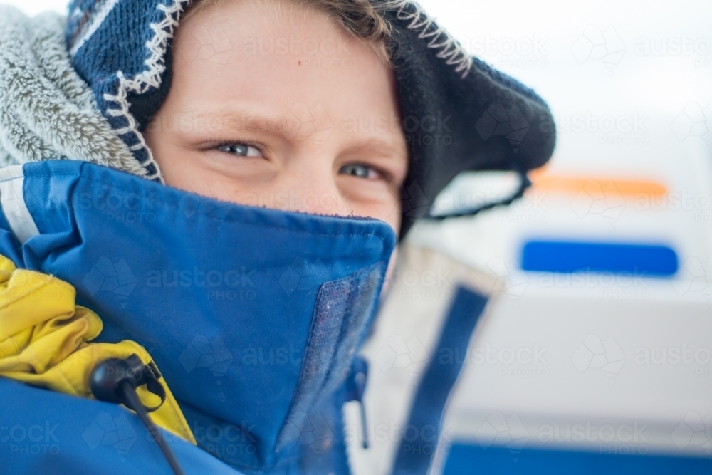 Boy rugged up with beanie and jacket on winter day - Australian Stock Image