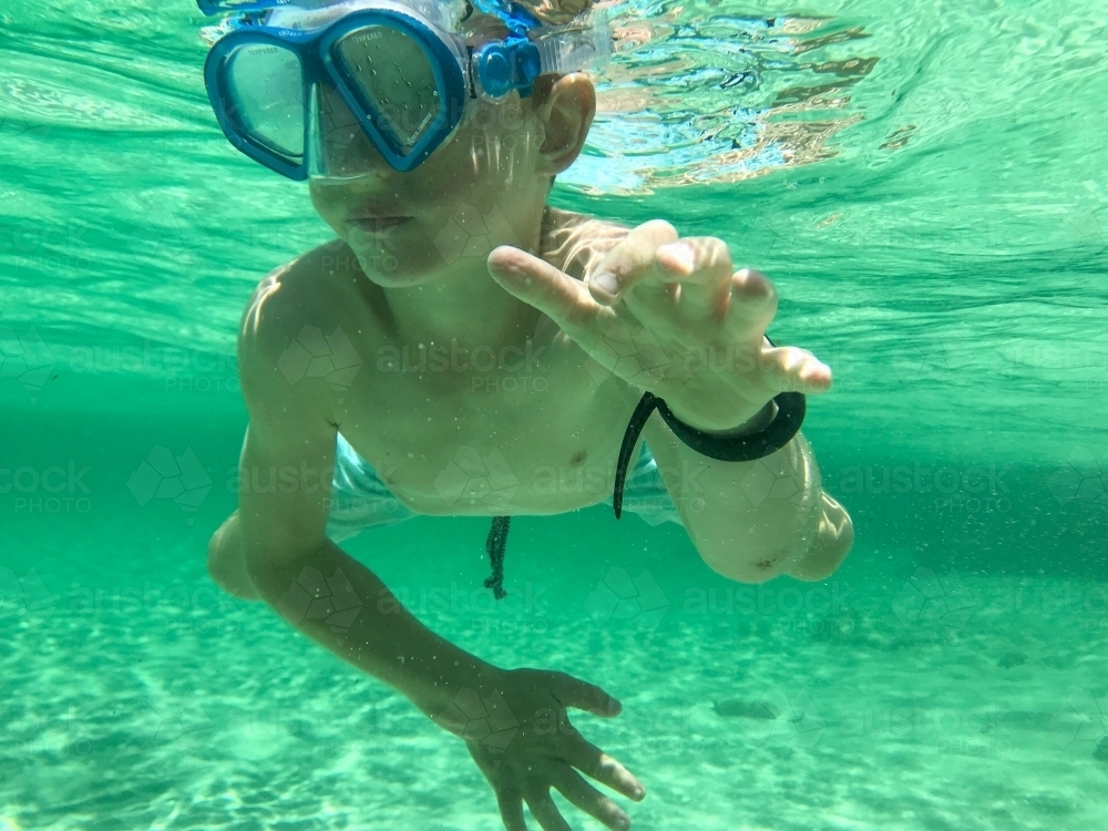 Boy snorkeling taken underwater - Australian Stock Image