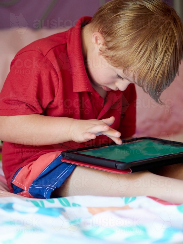 Boy Using Tablet Device - Australian Stock Image