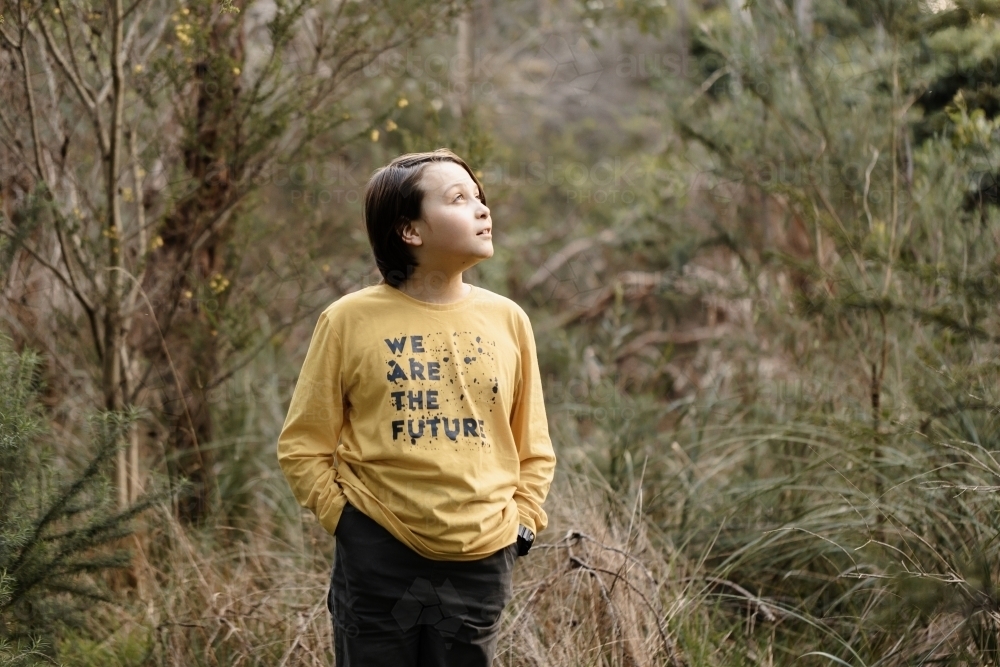 Boy wearing a generic yellow T-shirt that says we are the future - Australian Stock Image