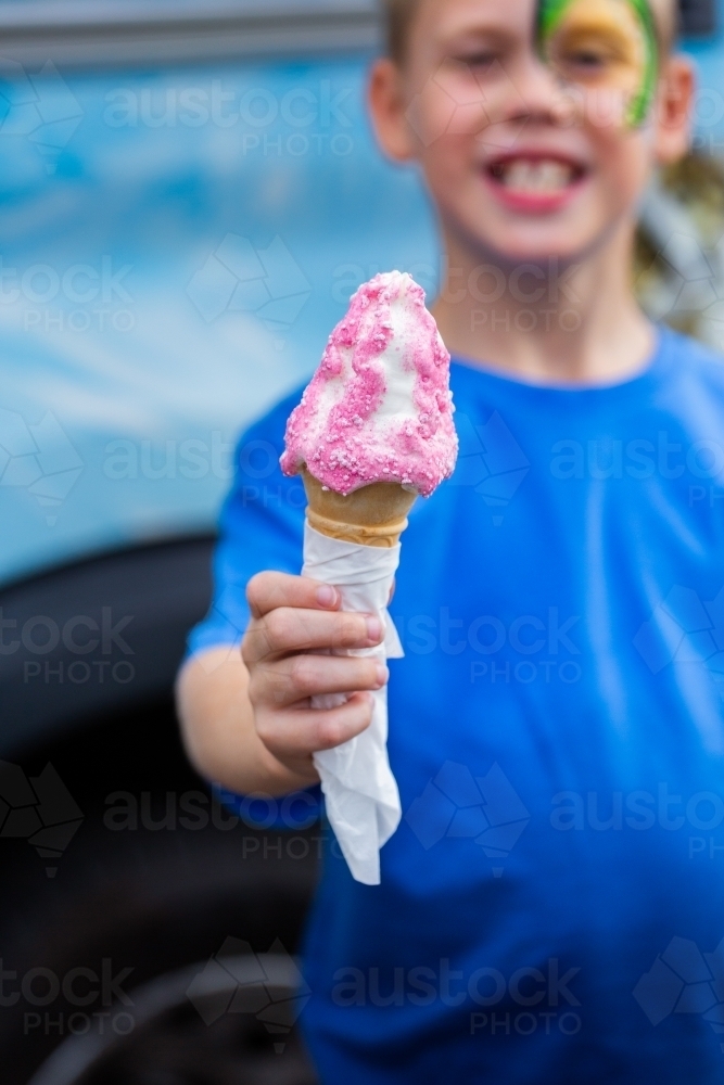 Boy with his ice cream Infront of ice-cream truck at event - Australian Stock Image