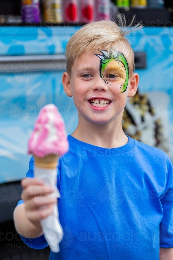 Boy with his ice cream Infront of ice-cream truck at event - Australian Stock Image