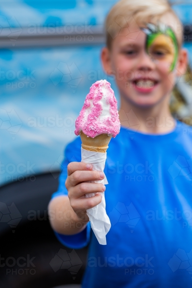 Boy with his ice cream infront of ice-cream truck at event - Australian Stock Image