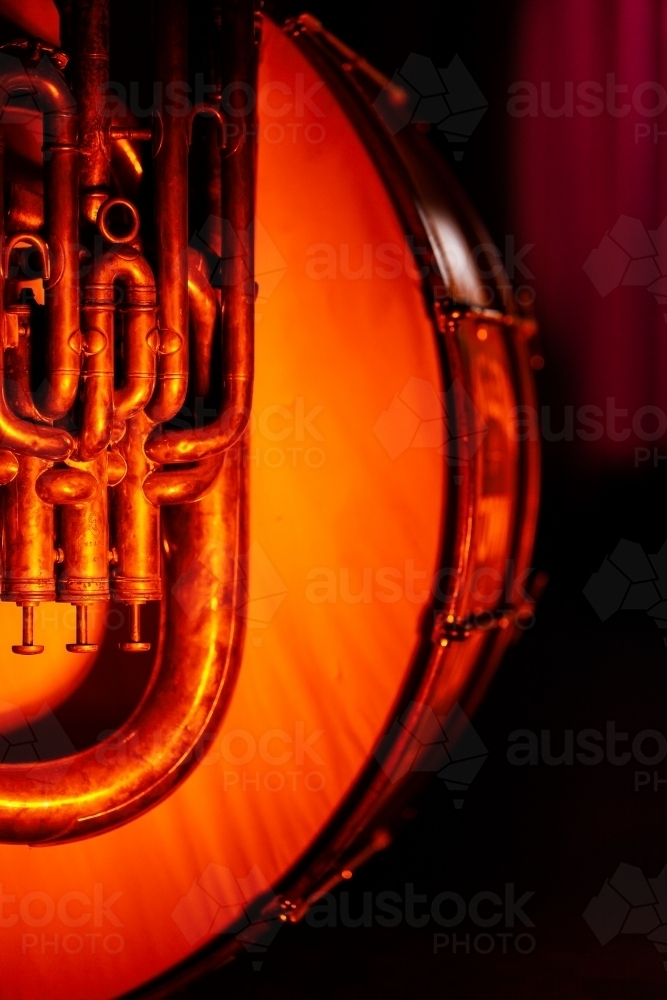 Brass musical instrument beside drum on stage at music concert - Australian Stock Image