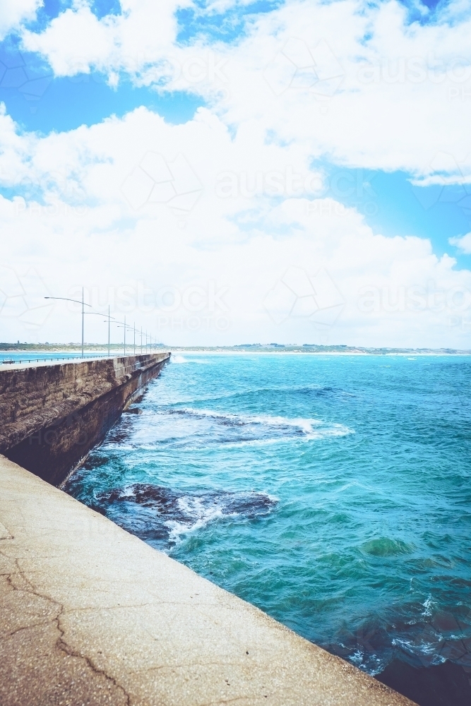 Breakwater wall in a coastal town - Australian Stock Image