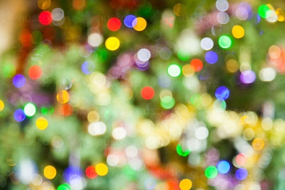Image of Bright colourful bokeh Christmas lights - Austockphoto