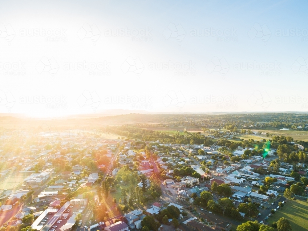 Bright evening sunflare light over road through country town in NSW Australia - Australian Stock Image