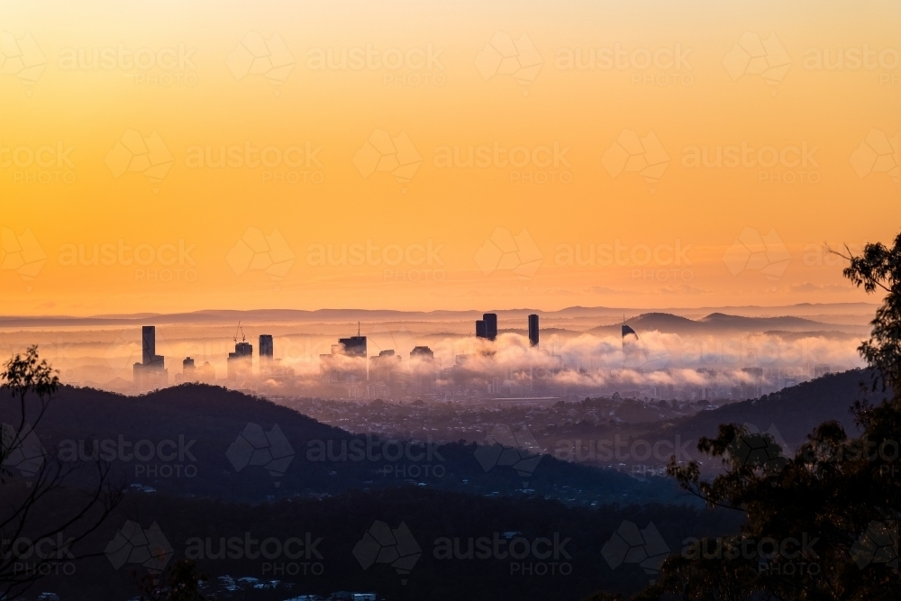 Brisbane city at sunrise covered in fog - Australian Stock Image