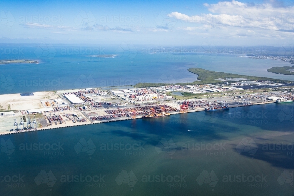 Brisbane River in foreground and Moreton Bay in background. Port of Brisbane facility middle. - Australian Stock Image