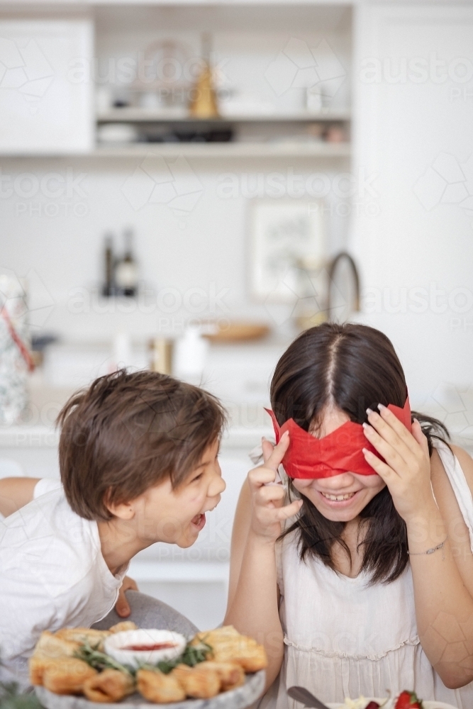 Brother and sister playing with paper crown - Australian Stock Image