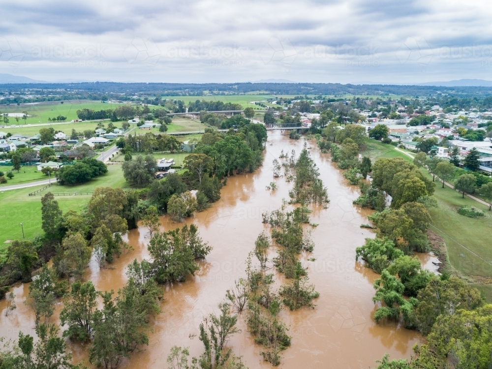 Brown floodwaters in Hunter River water falling after flood - Australian Stock Image