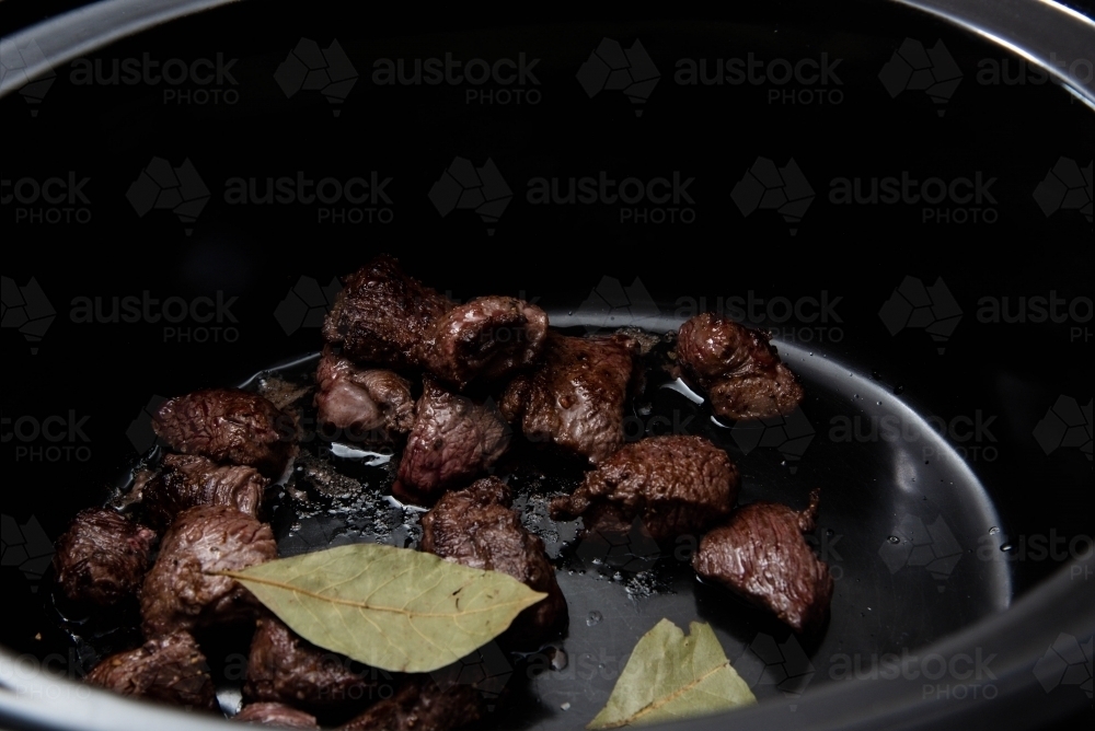 Browned meat in a slow cooker - Australian Stock Image