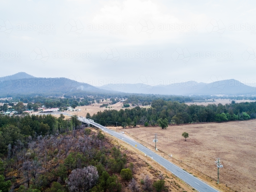 Bulga bridge and smoke filled sky over the hills and rural town - Australian Stock Image