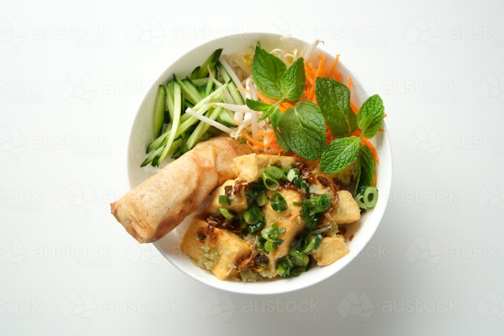 Bun Cha Gio bowl with fried tofu cubes topped with fried spring roll. - Australian Stock Image