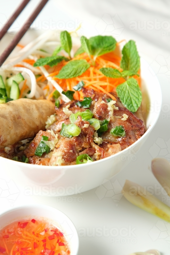 Bun Cha Gio bowl with meat slices topped with fried spring roll. - Australian Stock Image