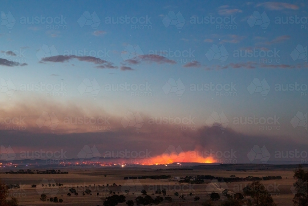 bushfire in rural landscape at dusk - Australian Stock Image